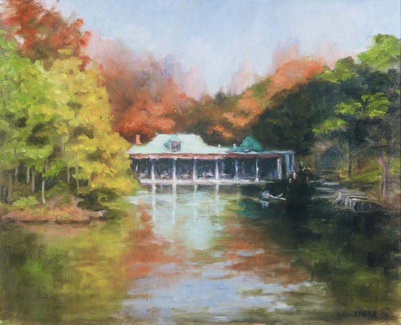 An antique pocket watch with a white face, black hands, and numbers, Inside a brown display box.