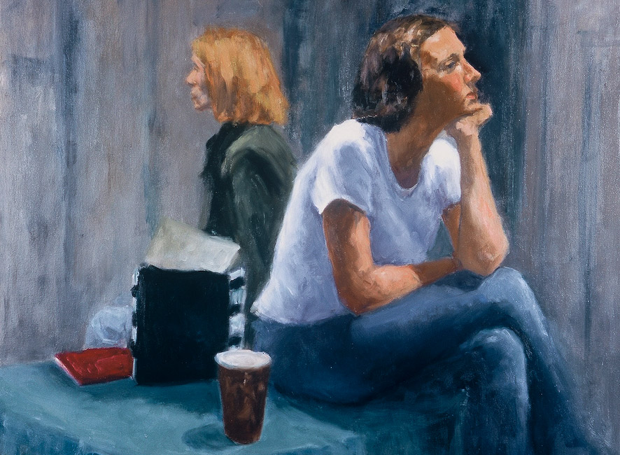 A thin piece of driftwood laying across speckled beige sand dunes, rising up diagonally in the distance.